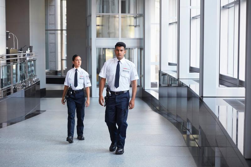 GardaWorld security services guards walking inside a building
