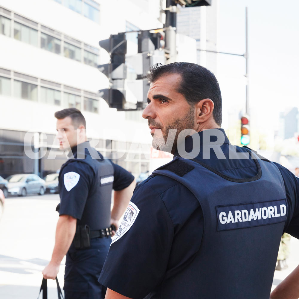 Cash Services, Agents wearing GardaWorld enscripted bulletproof vest on the lookout, outside operation (men)